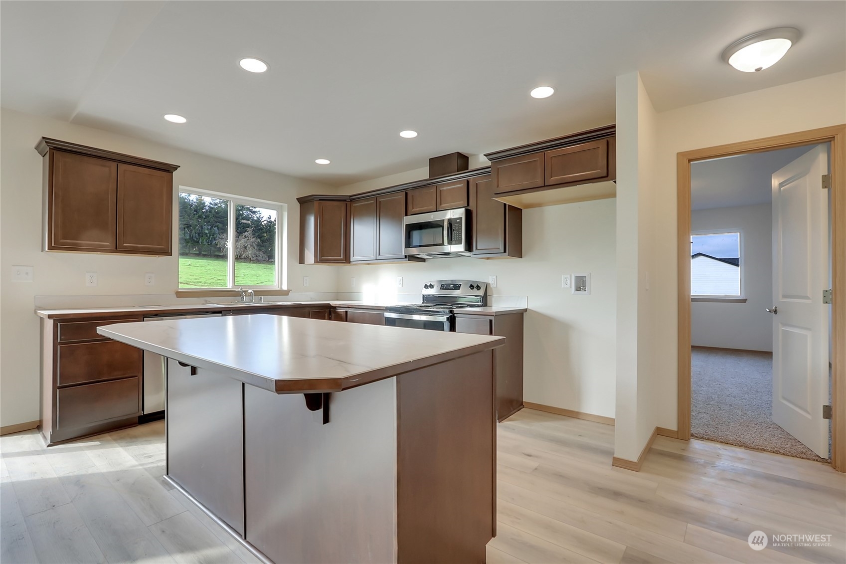 114 Gunnell Road Winlock, WA 98596 - Photo 5 of 23 a kitchen with kitchen island a sink appliances and cabinets