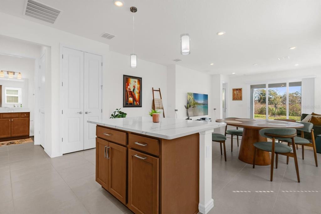 1911 Spring Shower Circle Kissimmee, FL 34744 - Photo 11 of 52 a kitchen with center island table and chairs in it