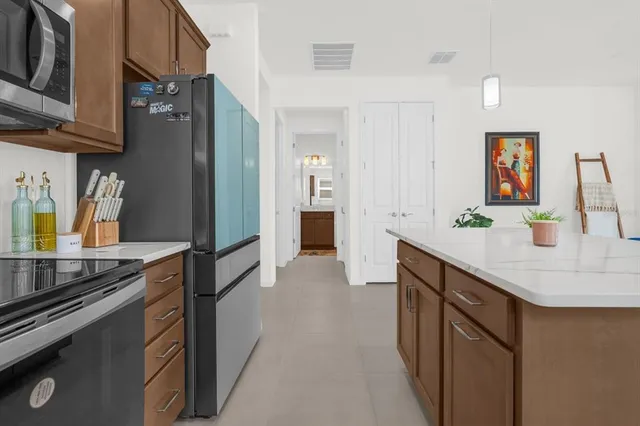 a kitchen with stainless steel appliances granite countertop a sink stove and refrigerator