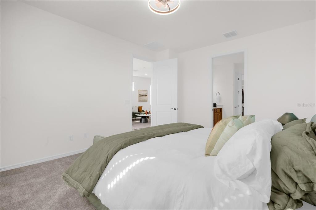 1911 Spring Shower Circle Kissimmee, FL 34744 - Photo 17 of 52 a bedroom with a bed and white tub