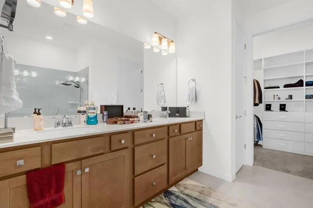 a spacious bathroom with a double vanity sink and a mirror