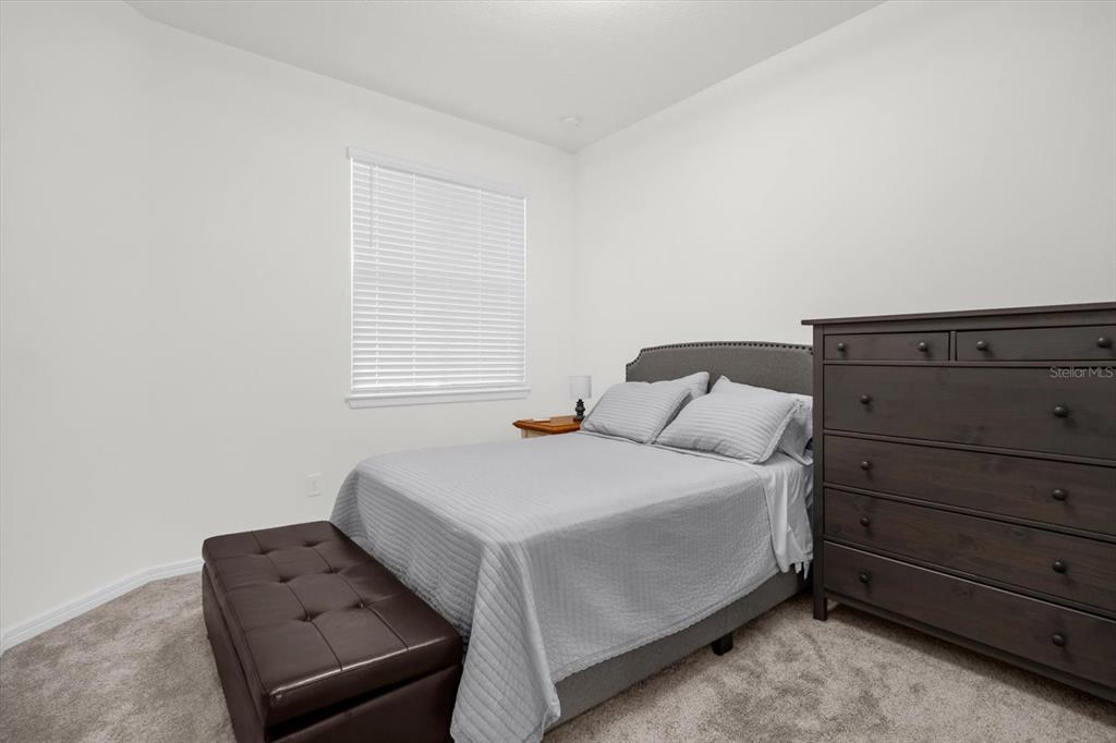 1911 Spring Shower Circle Kissimmee, FL 34744 - Photo 23 of 52 a bedroom with a bed and window