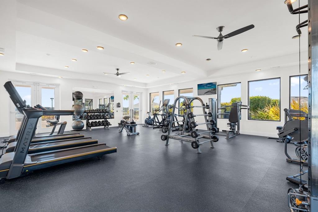 1911 Spring Shower Circle Kissimmee, FL 34744 - Photo 28 of 52 a gym room with lots of furniture and a chandelier