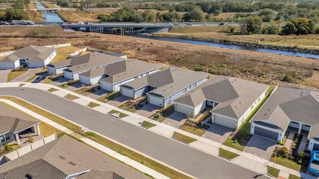an aerial view of residential houses with outdoor space
