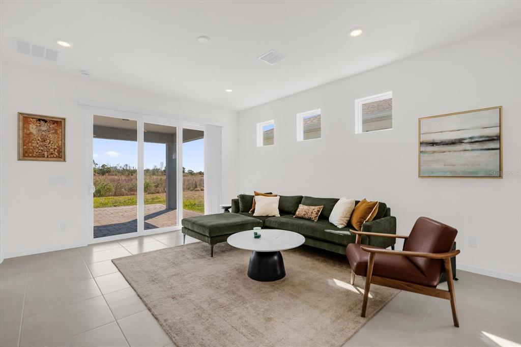 1911 Spring Shower Circle Kissimmee, FL 34744 - Photo 4 of 52 a living room with furniture and a floor to ceiling window