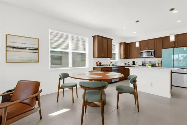 a kitchen with a table chairs stove and kitchen island