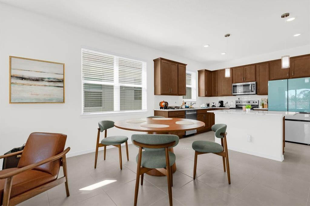1911 Spring Shower Circle Kissimmee, FL 34744 - Photo 6 of 52 a kitchen with a table chairs stove and kitchen island