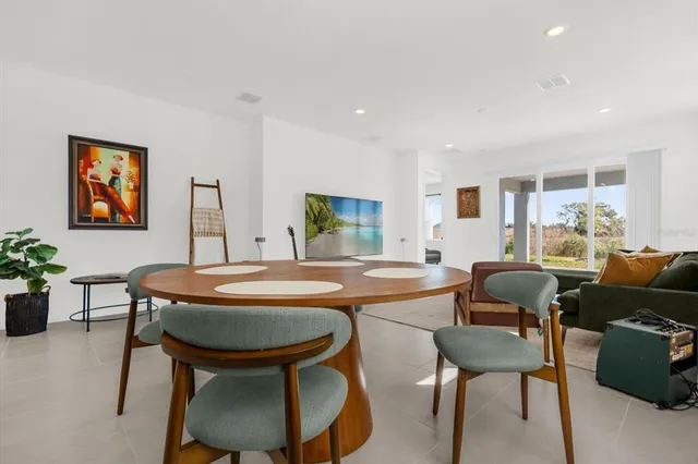 a dining room with furniture a window and a rug