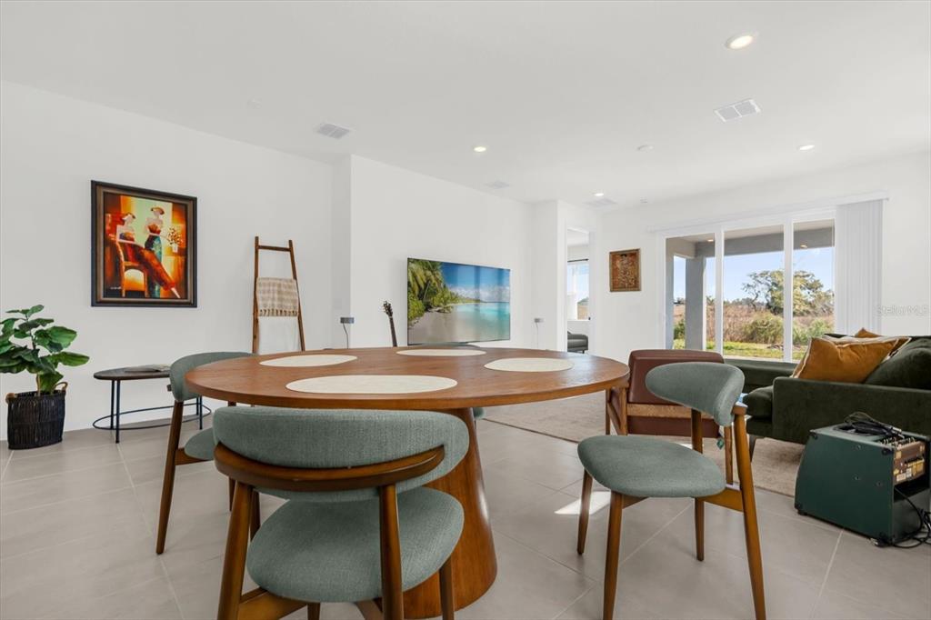 1911 Spring Shower Circle Kissimmee, FL 34744 - Photo 7 of 52 a dining room with furniture a window and a rug