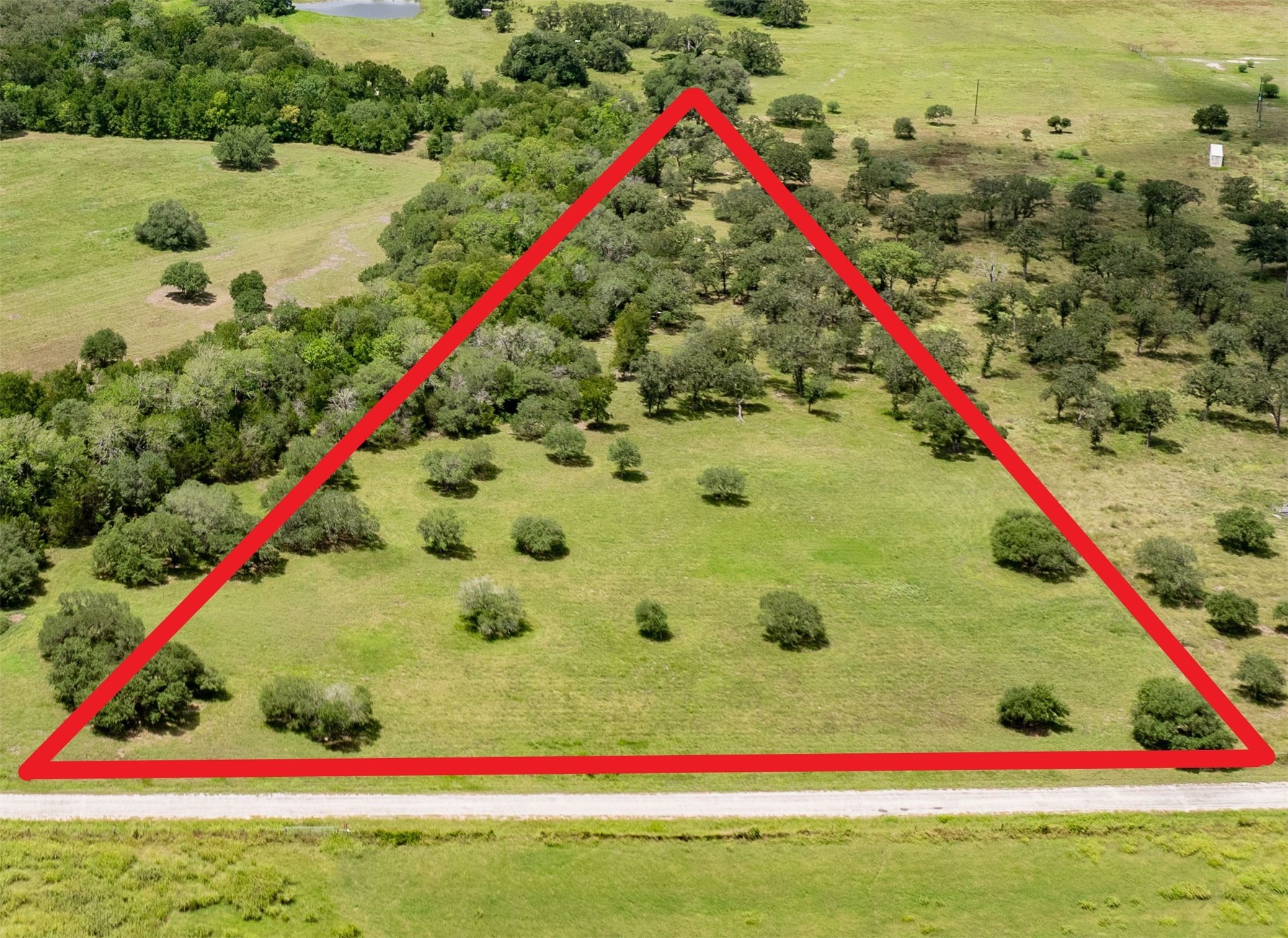 6800 Waldeck Cemetery Road Round Top, TX 78954 - Photo 7 of 8 a white and red umbrella sitting in a yard with potted plants