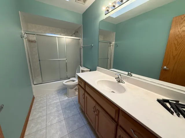 a spacious bathroom with a sink and mirror