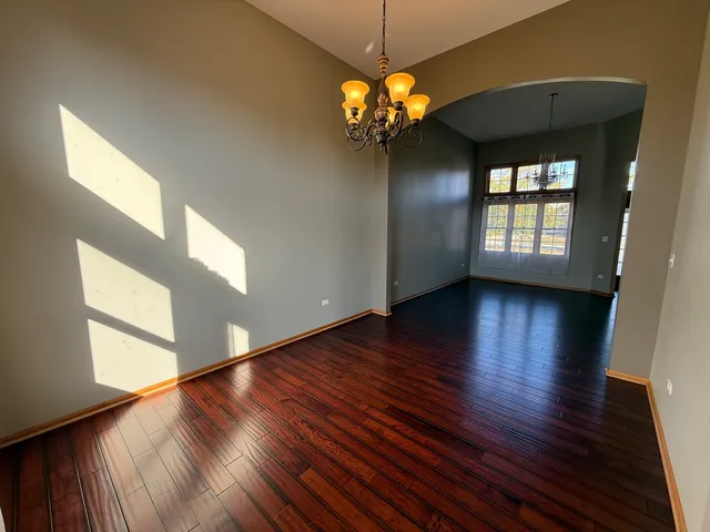 a view of a room with wooden floor and a window