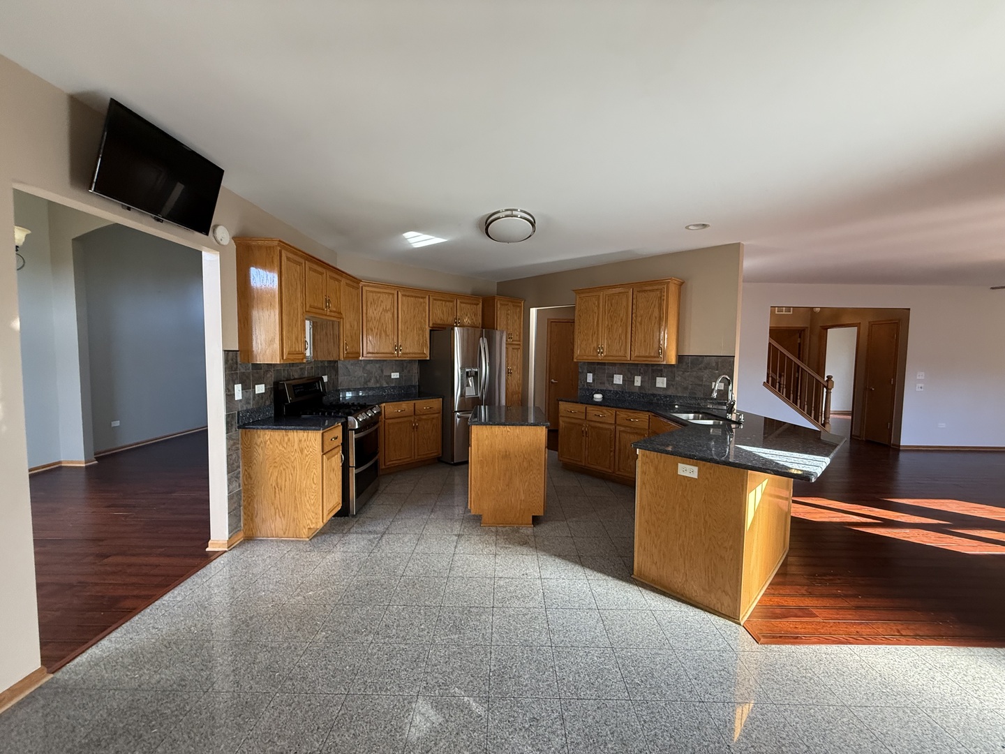 12457 Walden Road Homer Glen, IL 60491 - Photo 7 of 20 a kitchen with stainless steel appliances granite countertop a refrigerator and a stove top oven