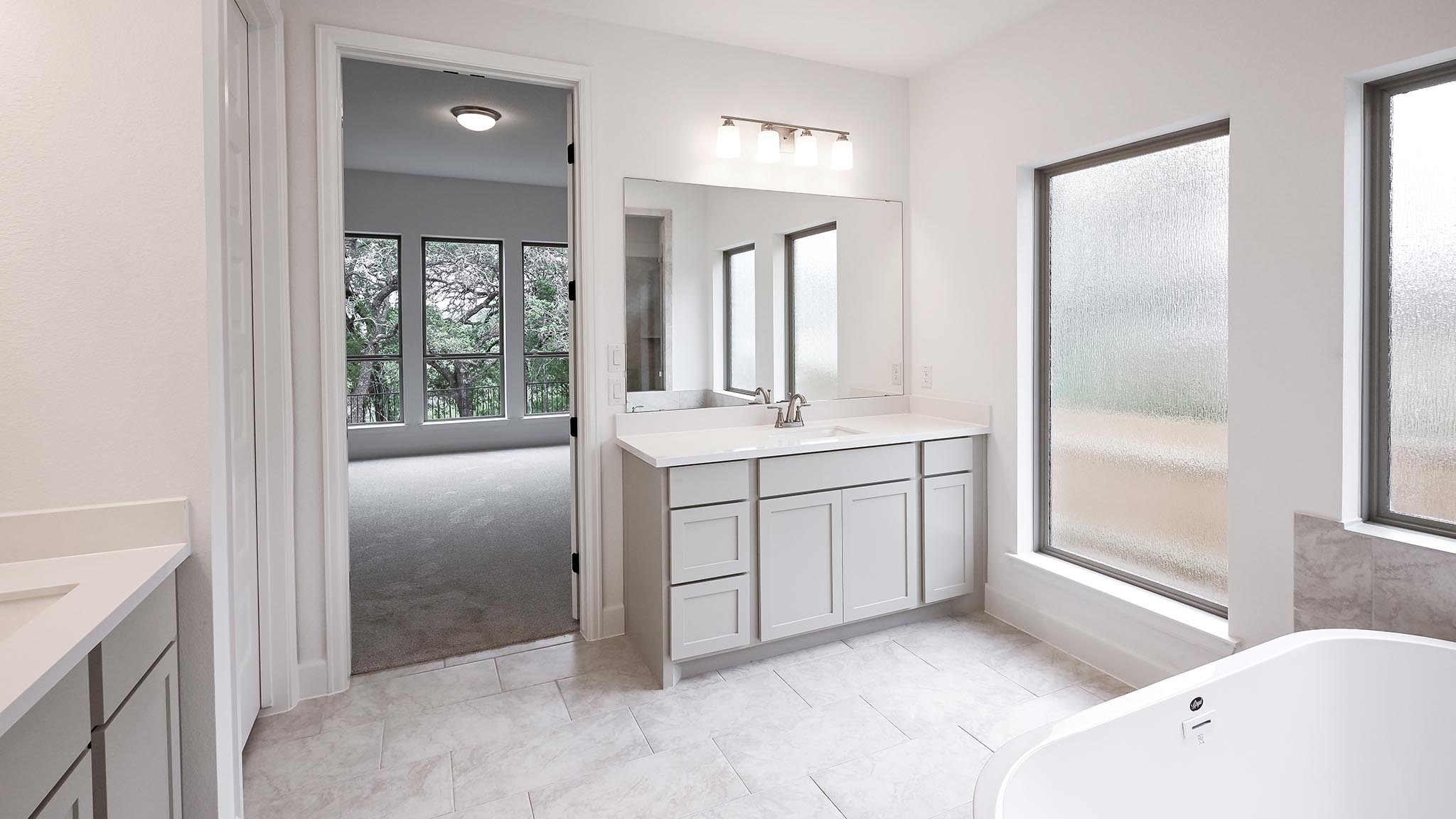 268 Basket Flower Loop Kyle, TX 78640 - Photo 19 of 27 a bathroom with a tub sink and mirror
