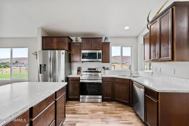 a bathroom with a sink double vanity granite and a mirror