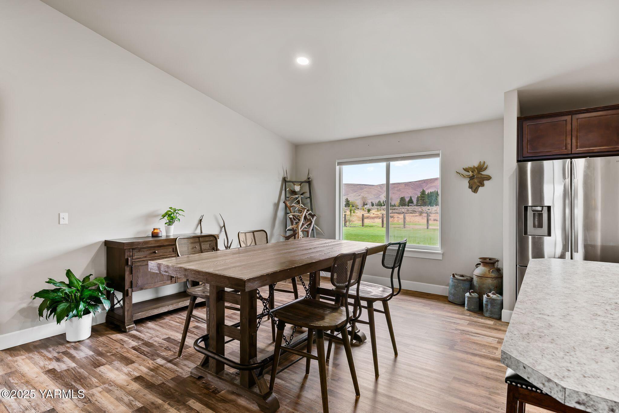 192 Sage Cove Road Yakima, WA 98903 - Photo 9 of 33 a view of a dining room with furniture window and wooden floor