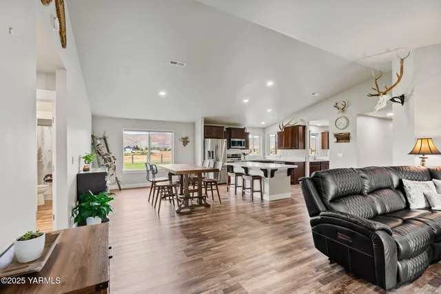a spacious bedroom with a bed and wooden floor