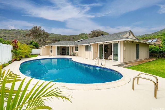 a view of a house with swimming pool and porch