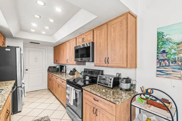 a kitchen with stainless steel appliances granite countertop a stove a sink and a microwave