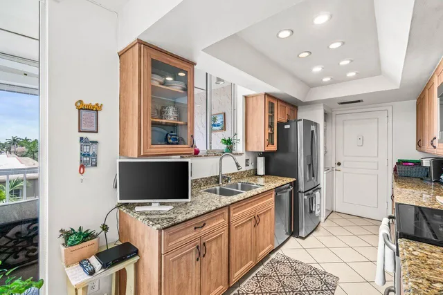 a kitchen with stainless steel appliances granite countertop a stove and a refrigerator