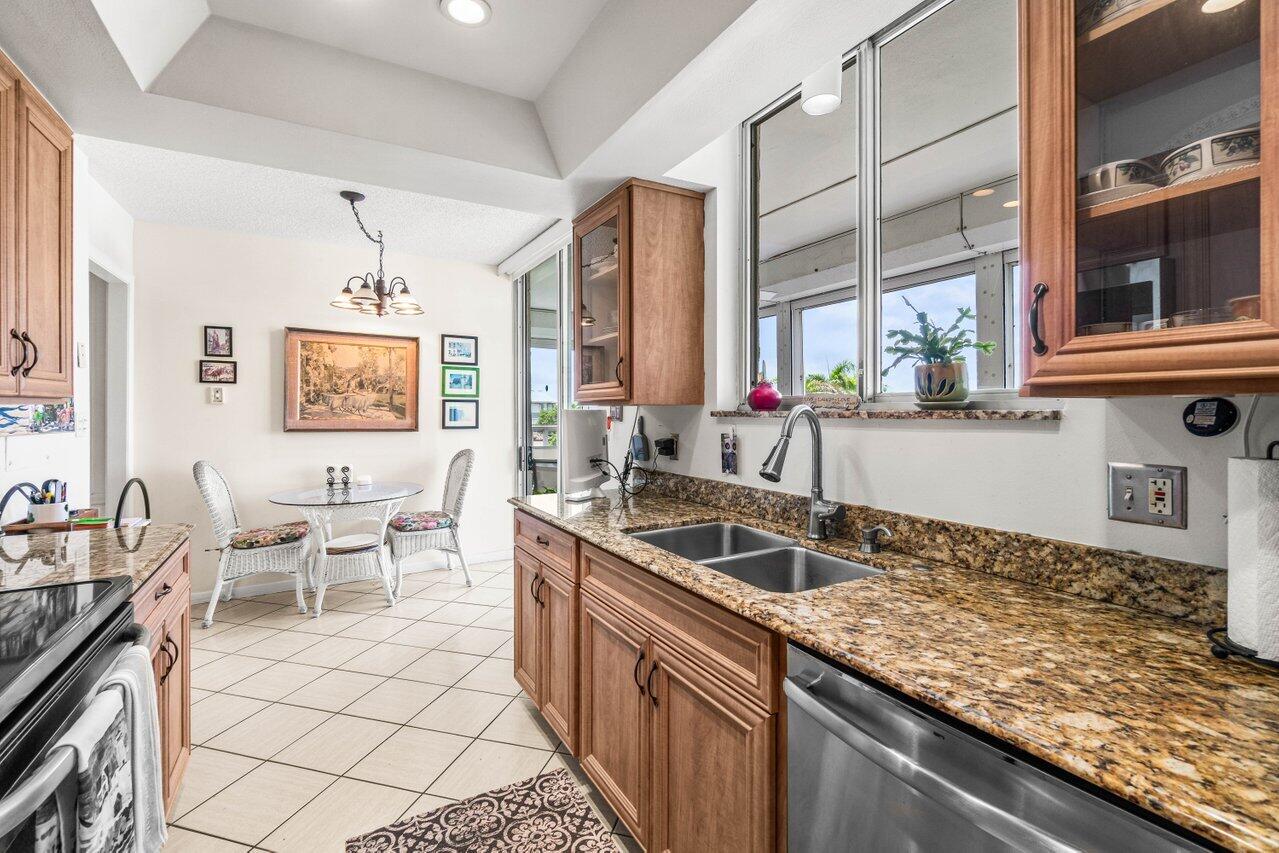 2000 South Ocean Boulevard, Unit 306 Delray Beach, FL 33483 - Photo 13 of 42 a kitchen with granite countertop a sink and a stove