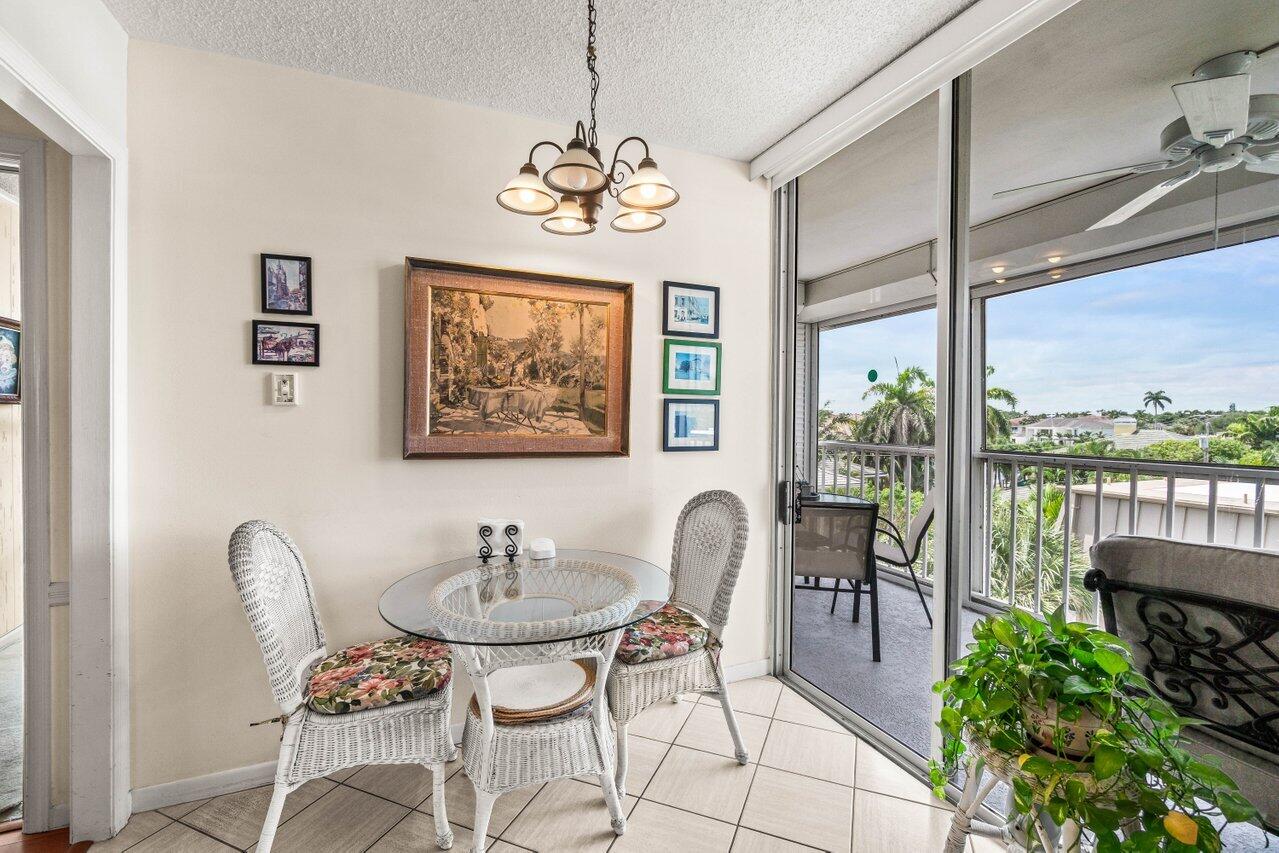 2000 South Ocean Boulevard, Unit 306 Delray Beach, FL 33483 - Photo 14 of 42 a dining room with furniture a window and a chandelier