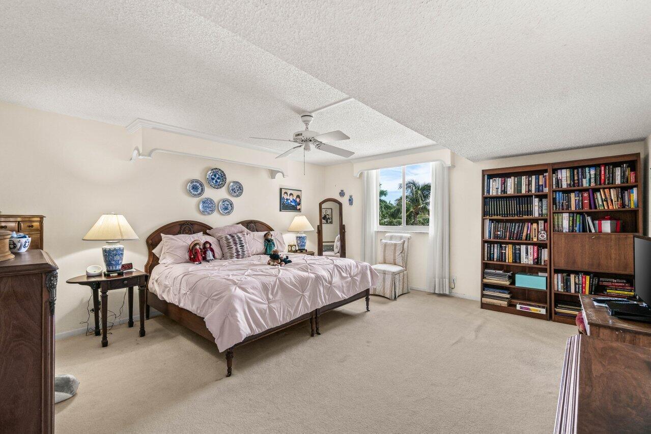 2000 South Ocean Boulevard, Unit 306 Delray Beach, FL 33483 - Photo 16 of 42 a bedroom with a bed a book shelf and a window