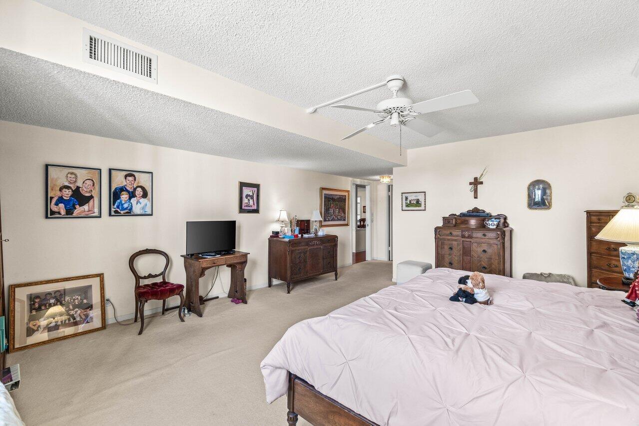 2000 South Ocean Boulevard, Unit 306 Delray Beach, FL 33483 - Photo 17 of 42 a bedroom with a bed and a chandelier