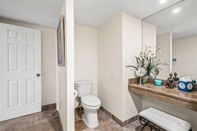 a bathroom with a toilet a sink and a mirror