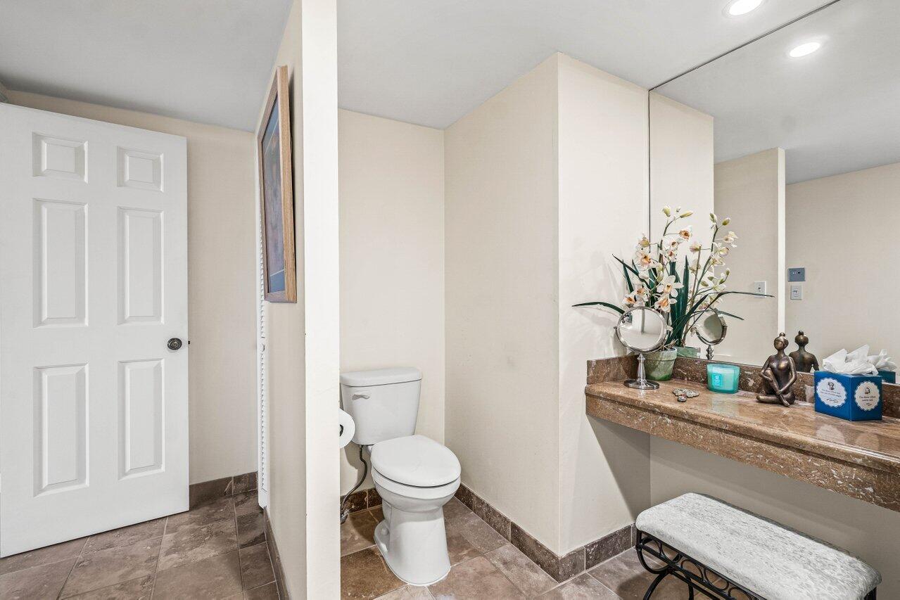 2000 South Ocean Boulevard, Unit 306 Delray Beach, FL 33483 - Photo 21 of 42 a bathroom with a toilet a sink and a mirror
