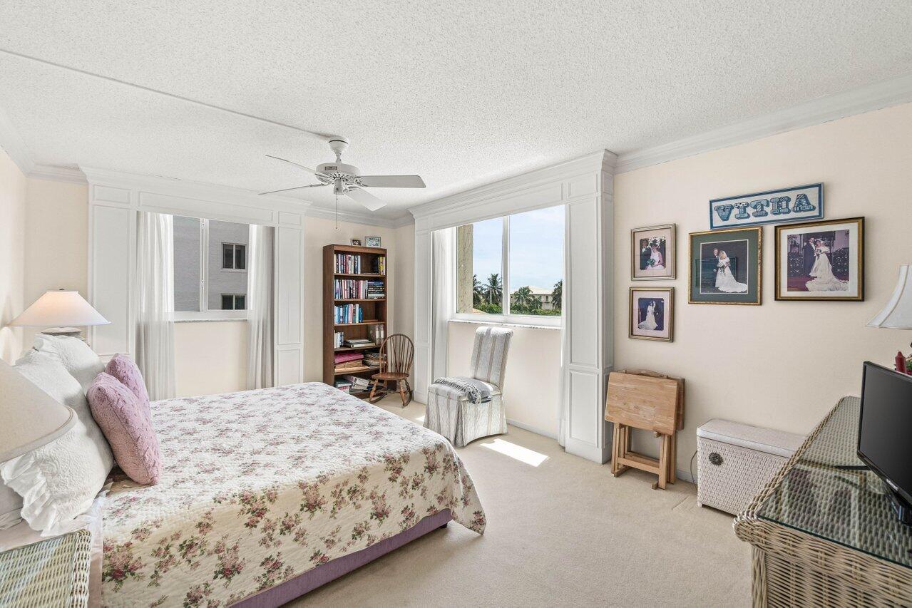 2000 South Ocean Boulevard, Unit 306 Delray Beach, FL 33483 - Photo 22 of 42 a bedroom with a large bed and a chandelier