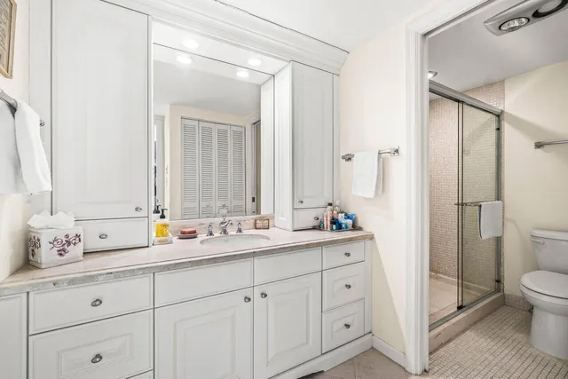 a en suite bathroom with a double vanity sink mirror and toilet