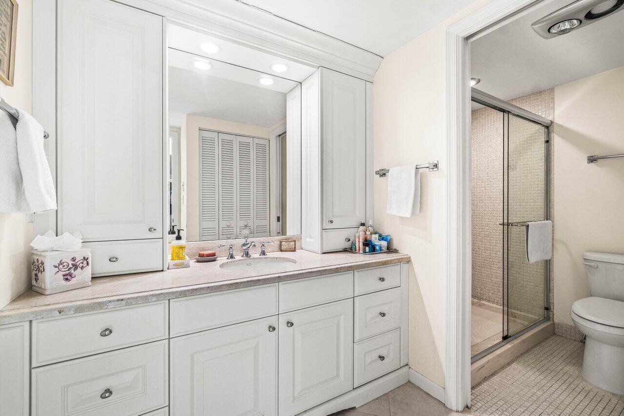 2000 South Ocean Boulevard, Unit 306 Delray Beach, FL 33483 - Photo 24 of 42 a en suite bathroom with a double vanity sink mirror and toilet