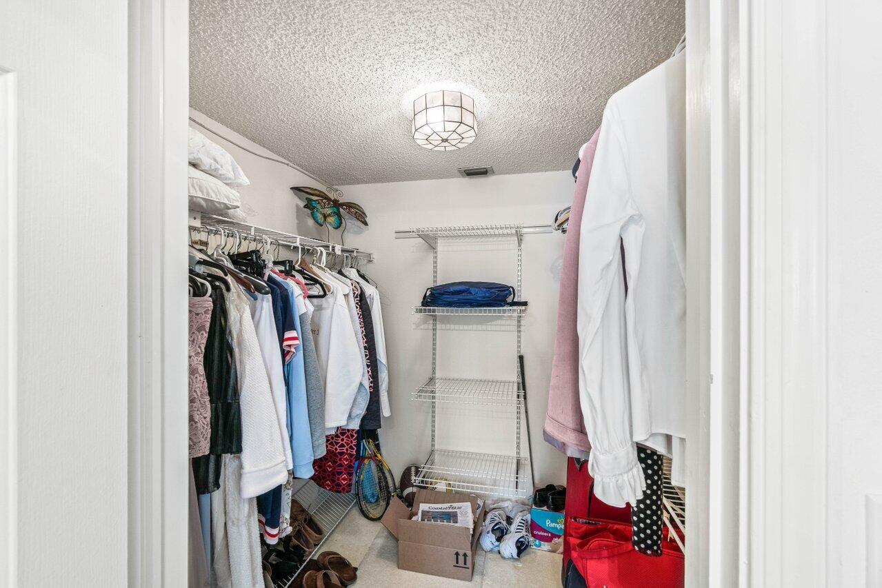 2000 South Ocean Boulevard, Unit 306 Delray Beach, FL 33483 - Photo 26 of 42 a view of walk in closet with clothes and shoes