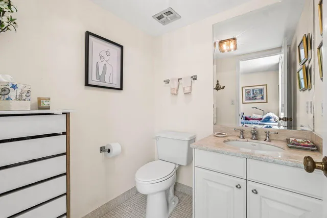 a bathroom with a sink toilet and vanity