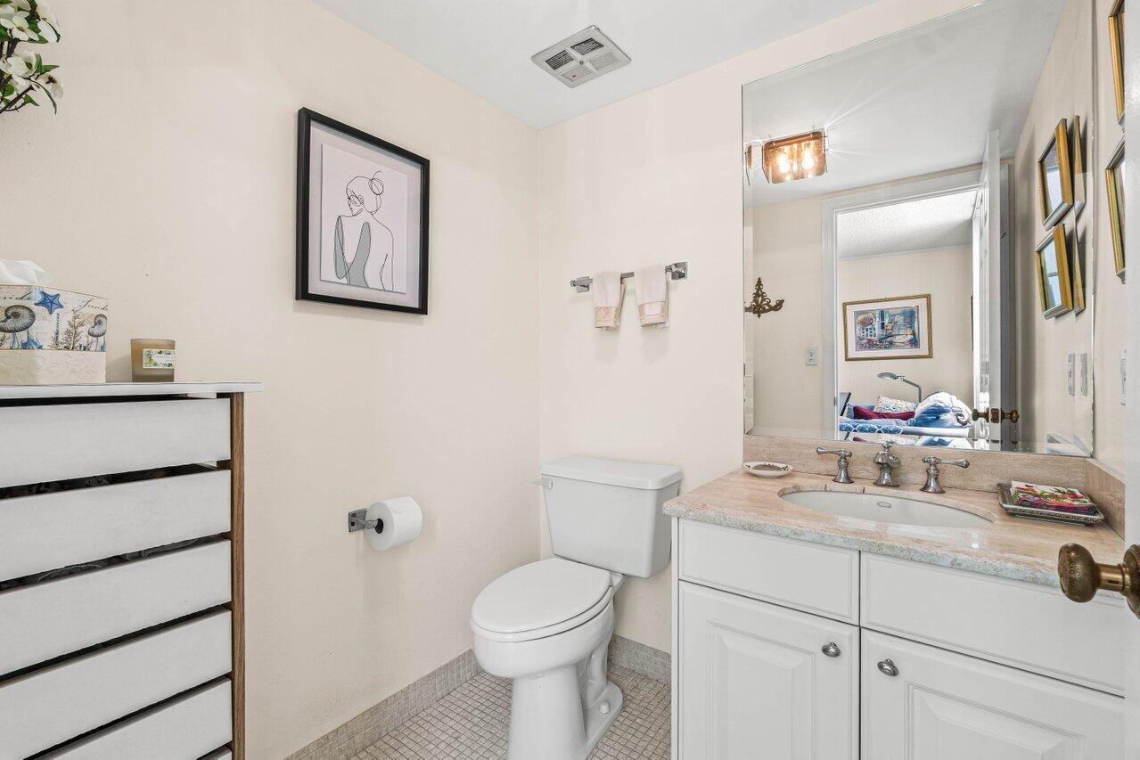 2000 South Ocean Boulevard, Unit 306 Delray Beach, FL 33483 - Photo 29 of 42 a bathroom with a sink toilet and vanity