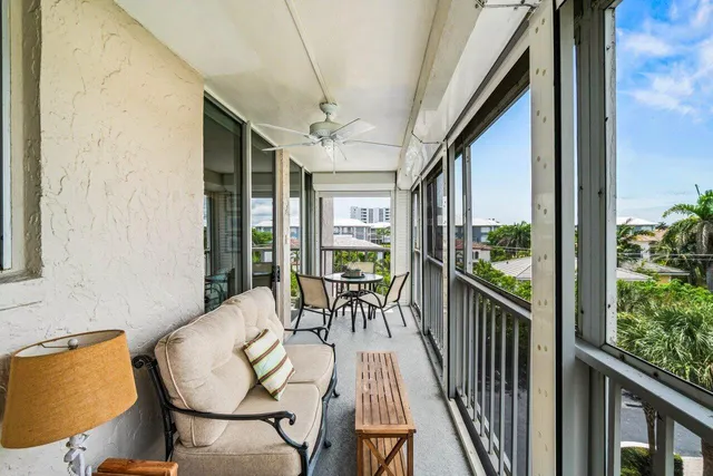 a view of a balcony with chairs and wooden floor