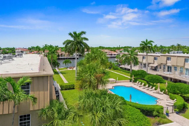 an aerial view of a swimming pool with a yard