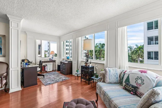 a bedroom with furniture and a large window