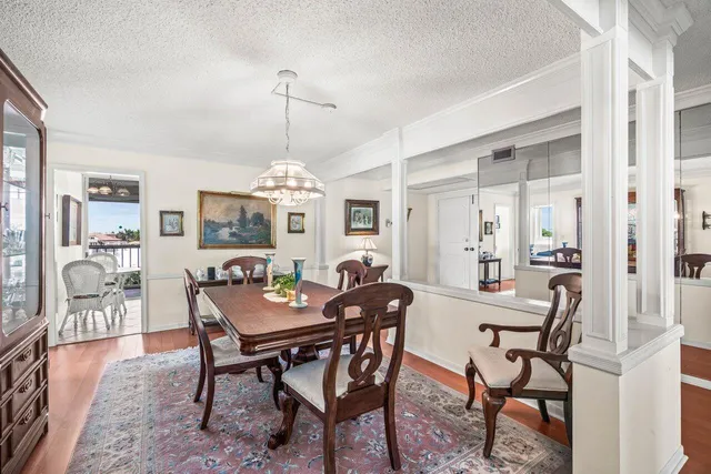 a view of a dining room with furniture and chandelier
