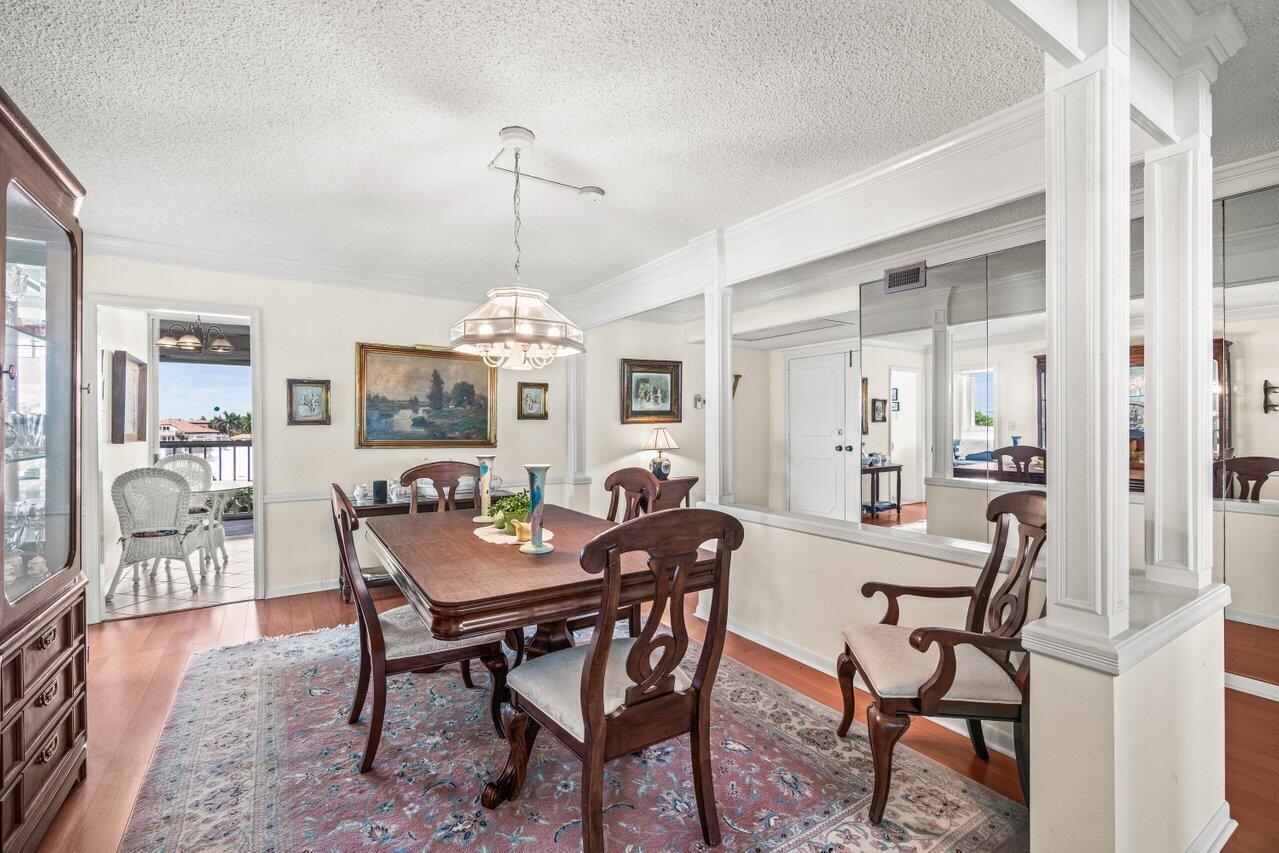 2000 South Ocean Boulevard, Unit 306 Delray Beach, FL 33483 - Photo 8 of 42 a view of a dining room with furniture and chandelier