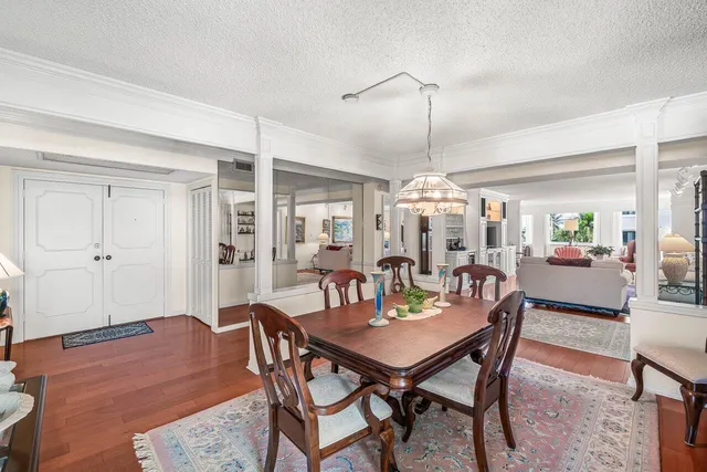 a dining room with furniture window and wooden floor