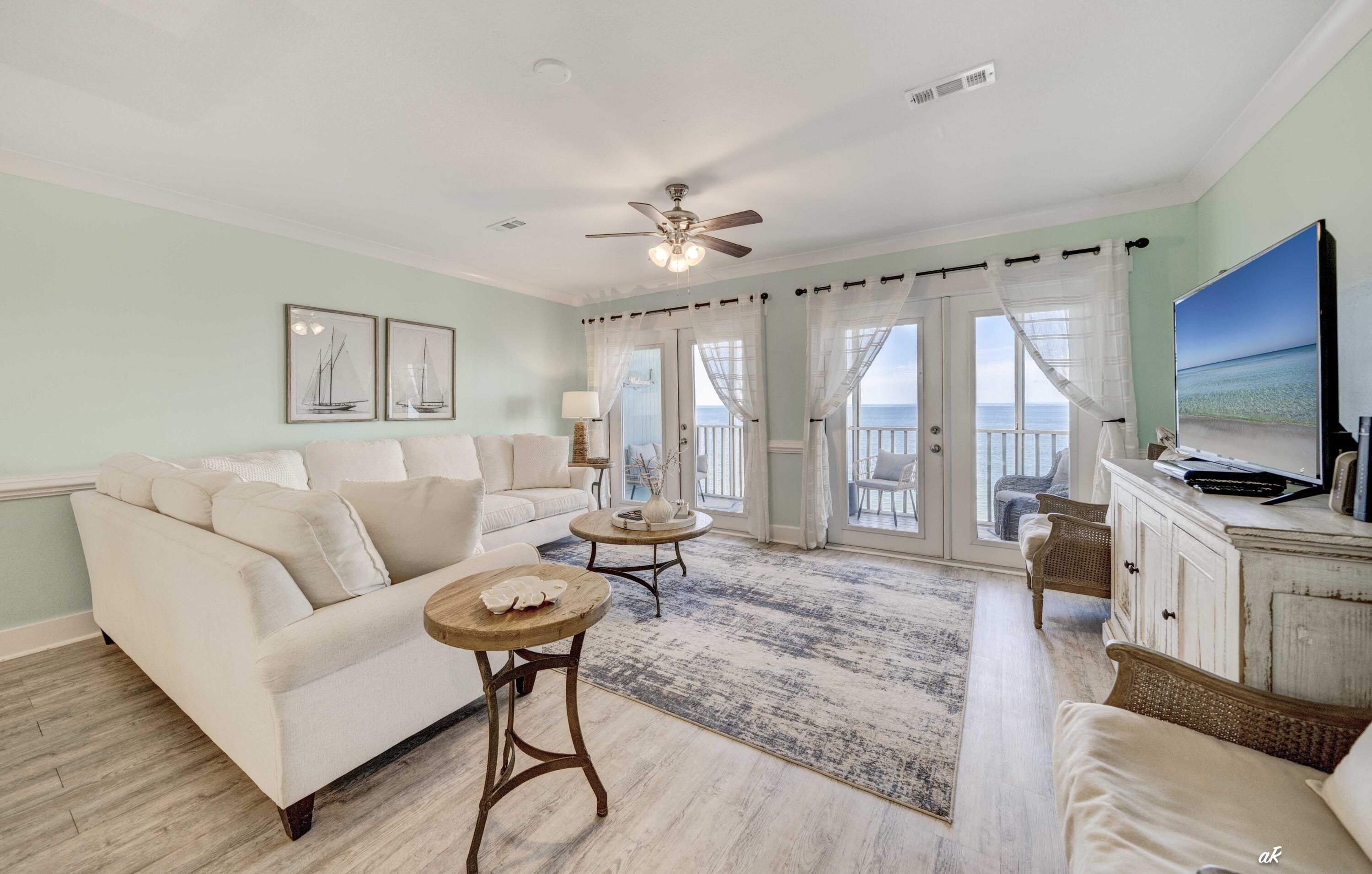 3869 Cape San Blas Road Port St. Joe, FL 32456 - Photo 11 of 52 a living room with furniture a flat screen tv and a large window