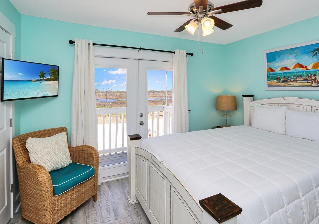 3869 Cape San Blas Road Port St. Joe, FL 32456 - Photo 17 of 52 a bedroom with a bed and a chandelier