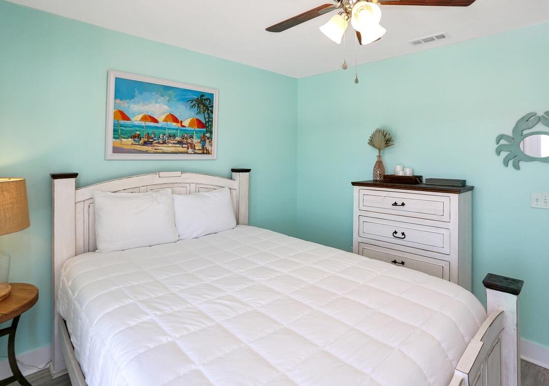 3869 Cape San Blas Road Port St. Joe, FL 32456 - Photo 18 of 52 a bedroom with a bed and a chandelier