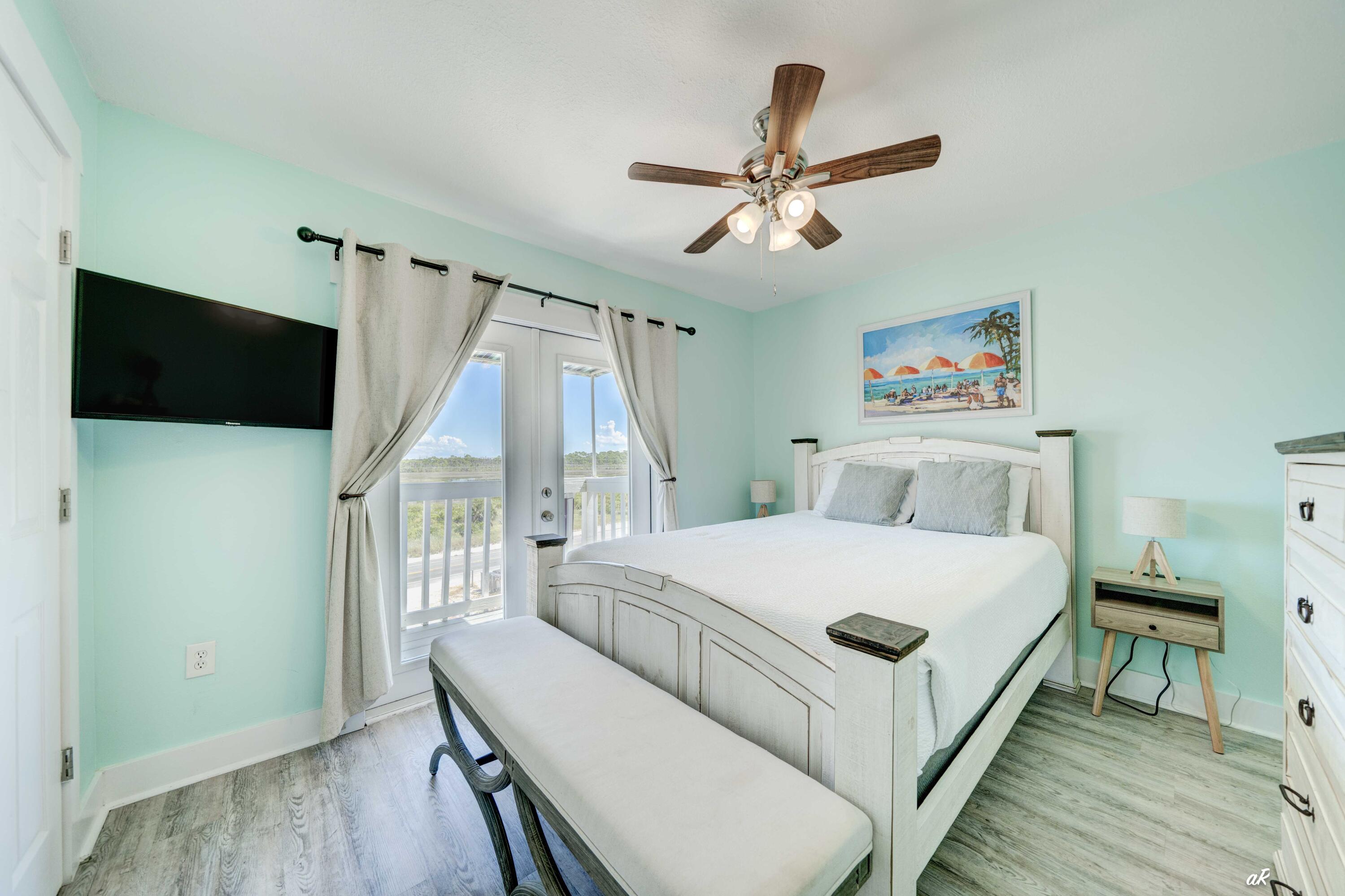 3869 Cape San Blas Road Port St. Joe, FL 32456 - Photo 26 of 52 a bedroom with a bed and a flat screen tv