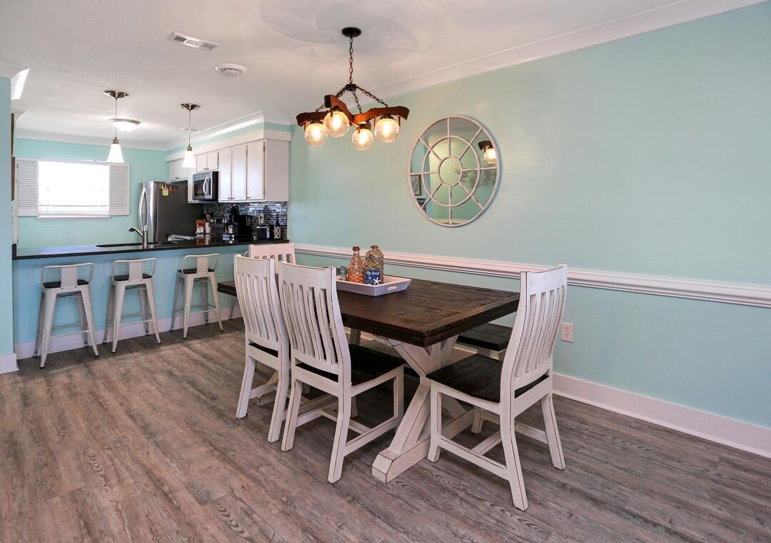 3869 Cape San Blas Road Port St. Joe, FL 32456 - Photo 39 of 52 a view of a dining room with furniture and wooden floor