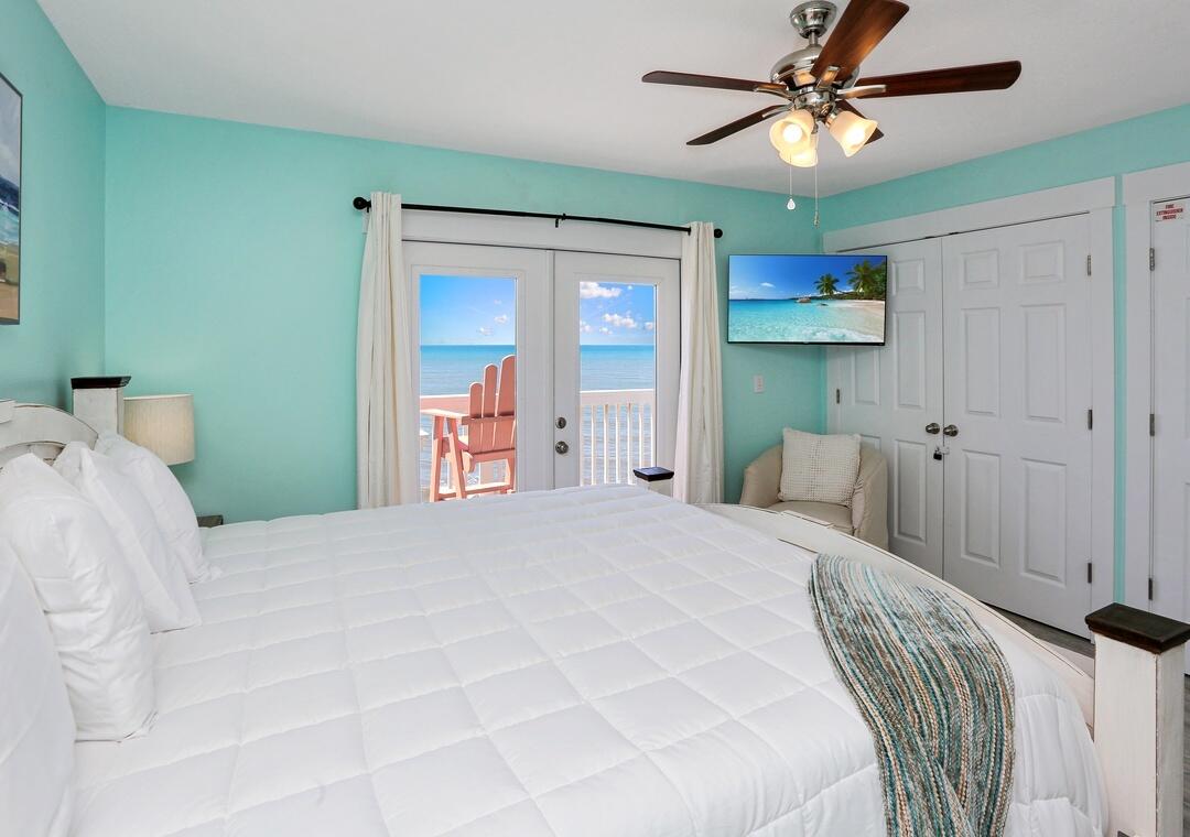 3869 Cape San Blas Road Port St. Joe, FL 32456 - Photo 48 of 52 a bedroom with a large bed and a chandelier
