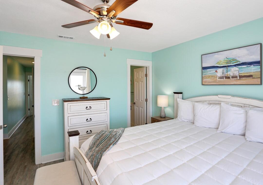 3869 Cape San Blas Road Port St. Joe, FL 32456 - Photo 51 of 52 a bedroom with a bed and a chandelier