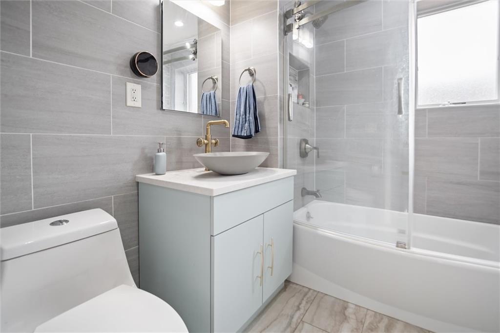 1523 74th Street, Unit 3F Brooklyn, NY 11228 - Photo 13 of 20 a bathroom with a sink toilet and shower